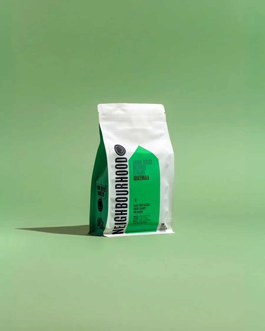 Neighbourhood coffee bag against a green background