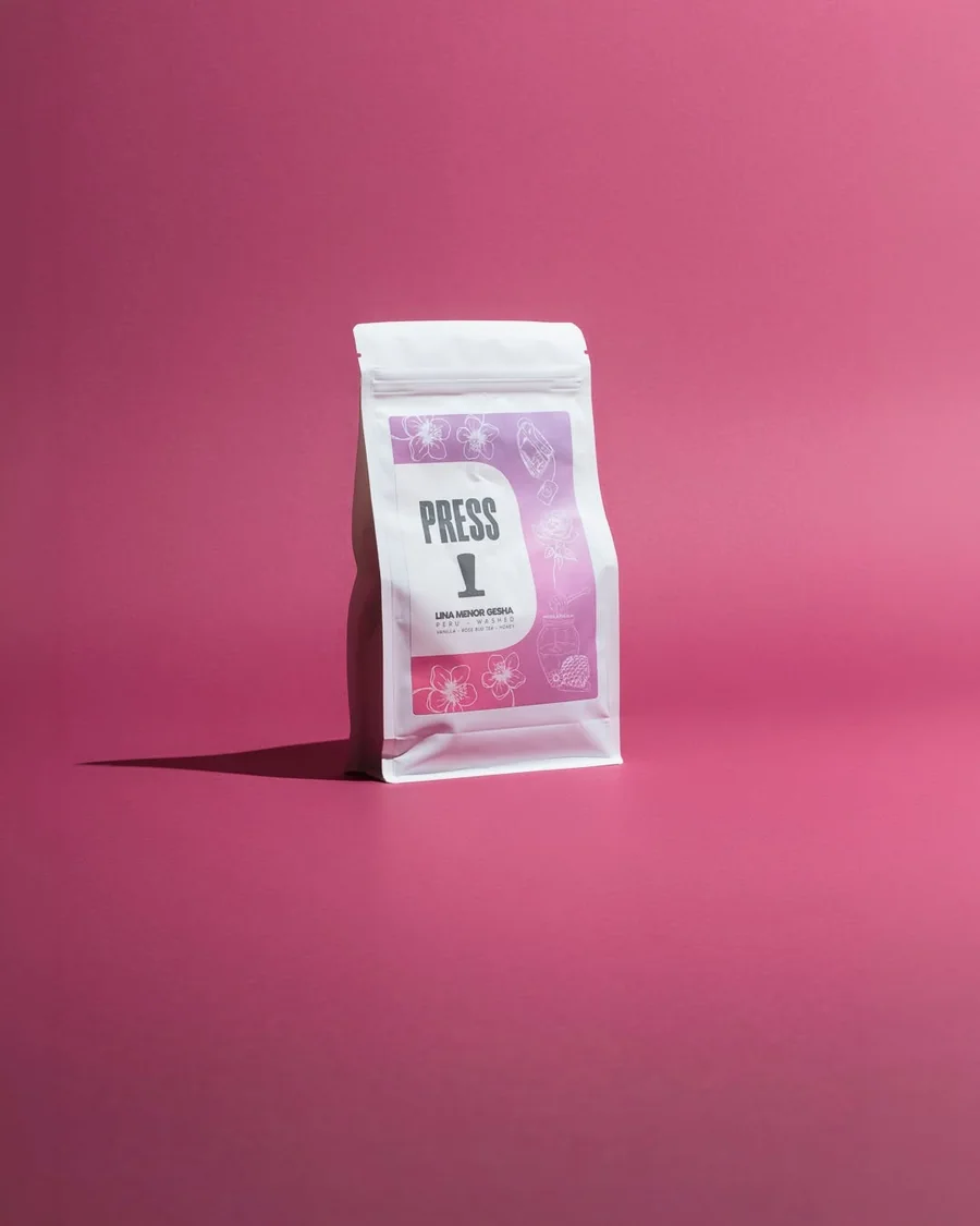 Press coffee bag against a pink background