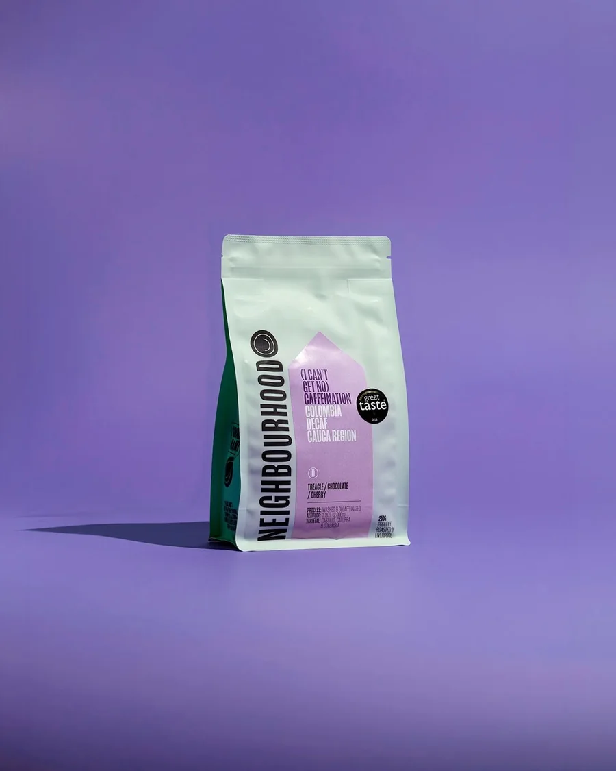 Neighbourhood coffee bag against a purple background