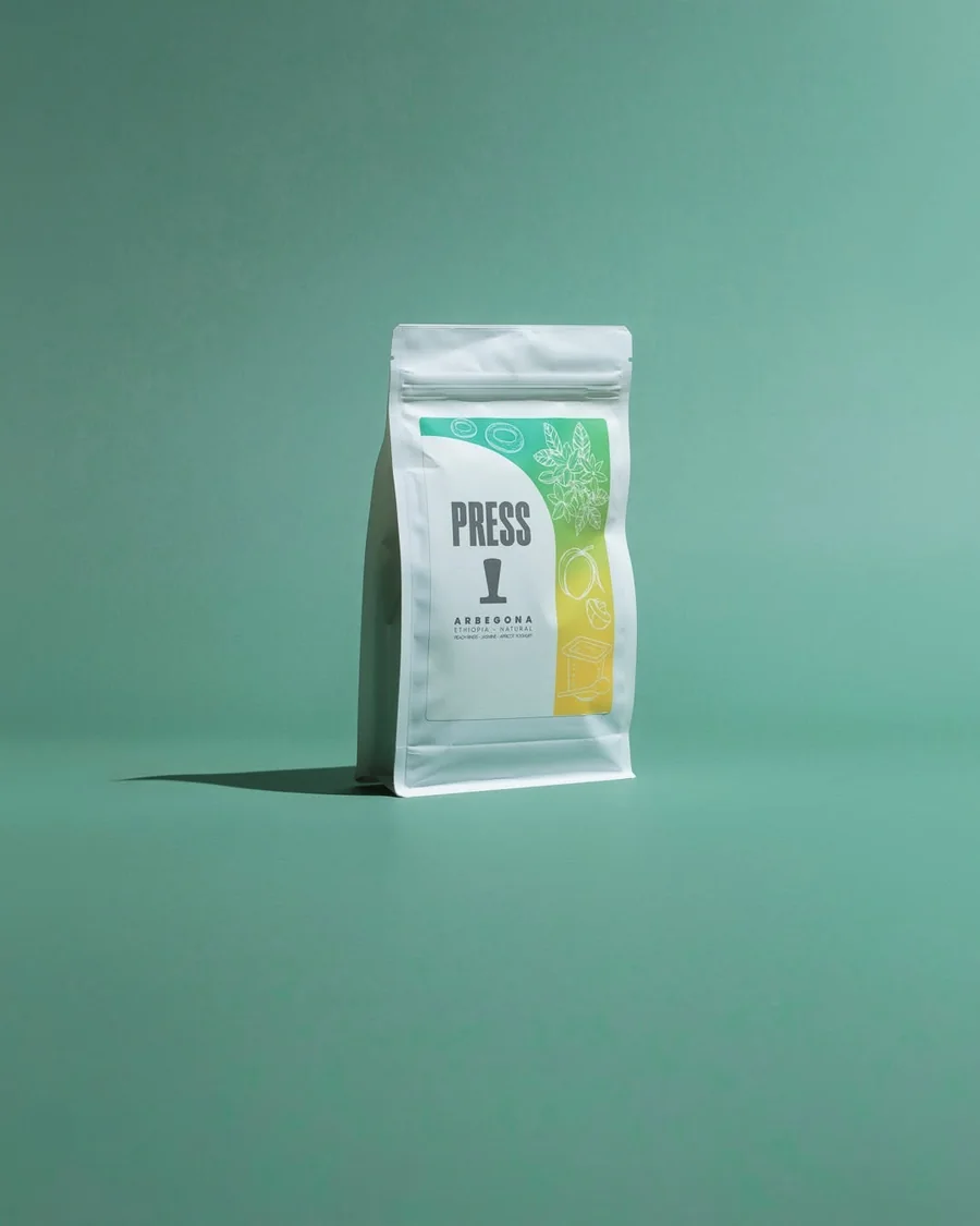 Press coffee bag against a teal background