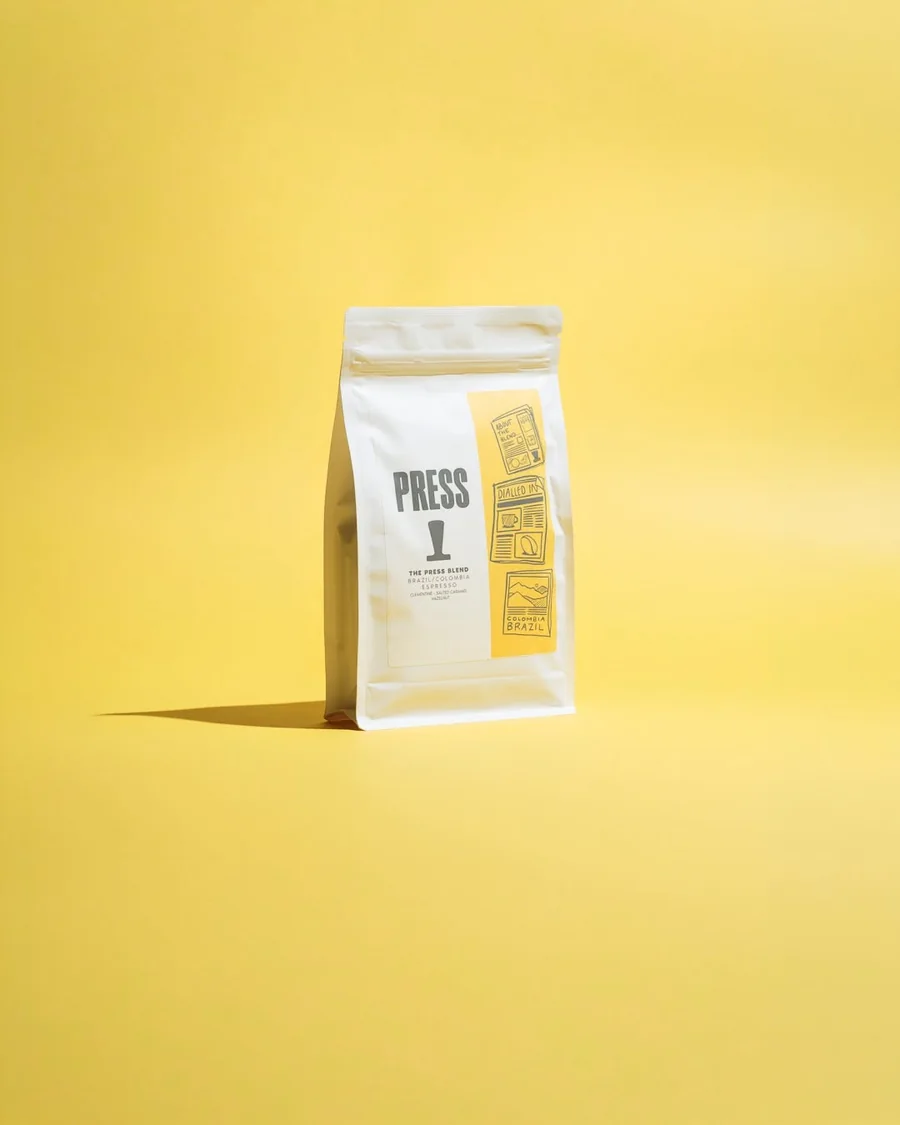 Press coffee bag against a yellow background